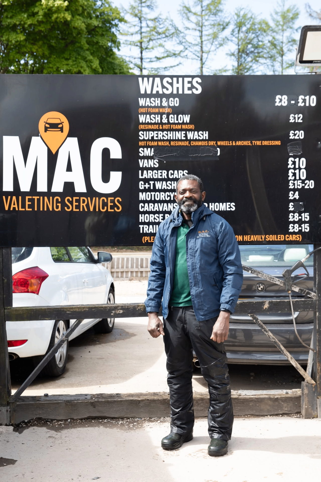 MAC Valeting Services owner in front of price board